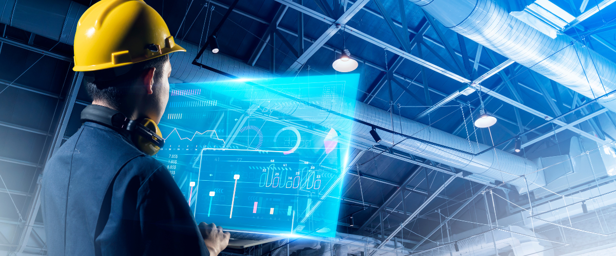 factory worker in front of a screen in a manufacturing warehouse